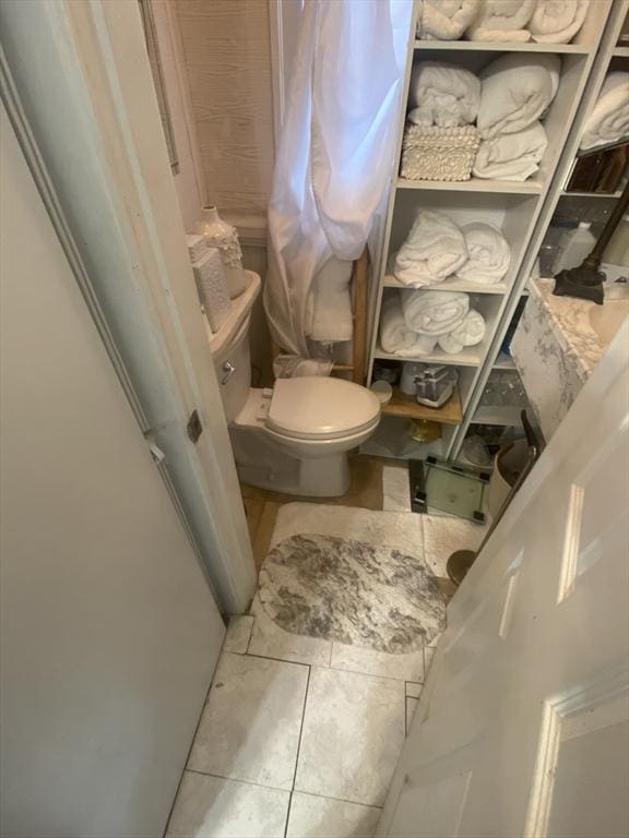 bathroom with tile patterned flooring and toilet