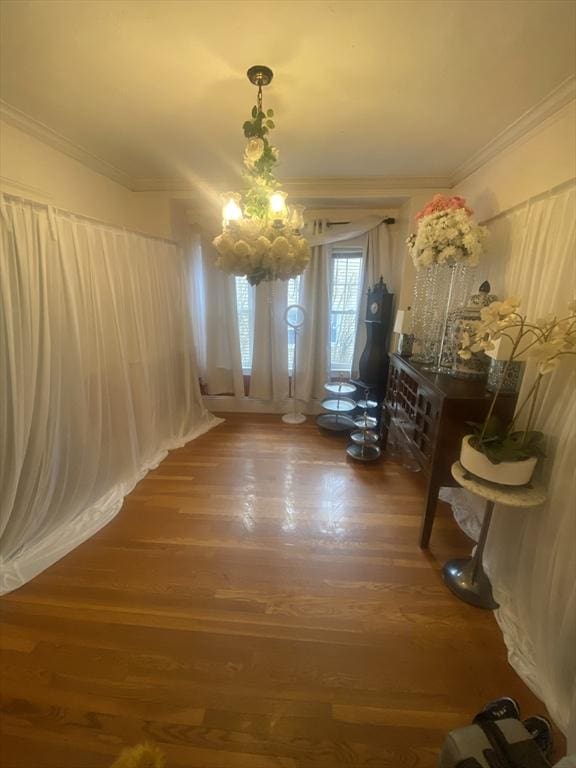 interior space with ornamental molding, dark hardwood / wood-style flooring, and a notable chandelier