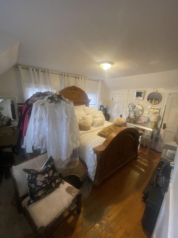 bedroom with dark hardwood / wood-style flooring and vaulted ceiling