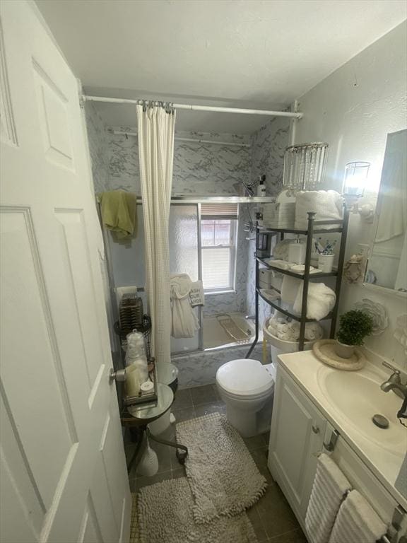 full bathroom with tile patterned floors, shower / bath combination with curtain, toilet, and vanity