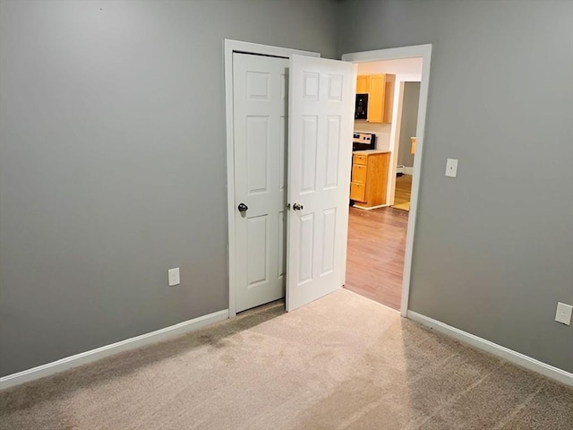 unfurnished bedroom featuring a closet and carpet floors