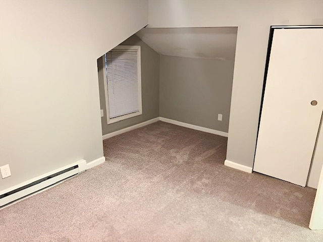 bonus room featuring light carpet and a baseboard radiator