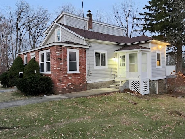 rear view of property with a lawn