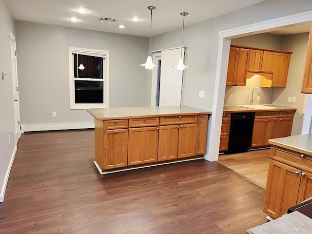 kitchen with kitchen peninsula, dark hardwood / wood-style flooring, a baseboard radiator, black dishwasher, and hanging light fixtures