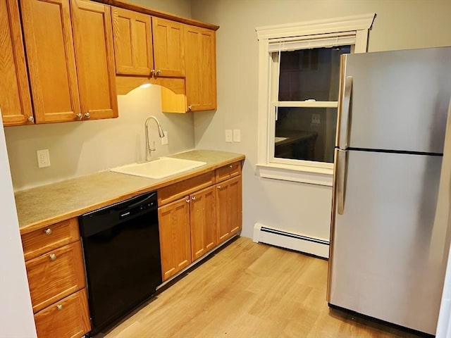 kitchen featuring sink, a baseboard radiator, black dishwasher, stainless steel fridge, and light hardwood / wood-style floors