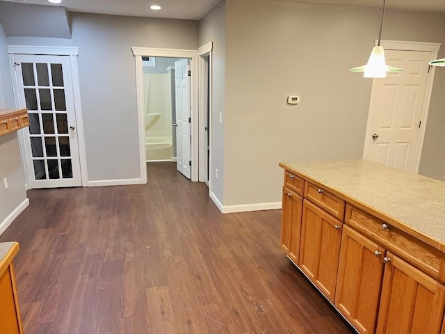 kitchen with dark hardwood / wood-style flooring and hanging light fixtures