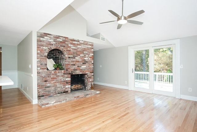 unfurnished living room featuring ceiling fan, a fireplace, light hardwood / wood-style floors, and vaulted ceiling