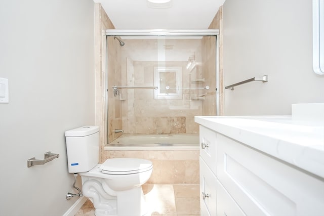 full bathroom with tile patterned floors, vanity, toilet, and shower / bath combination with glass door