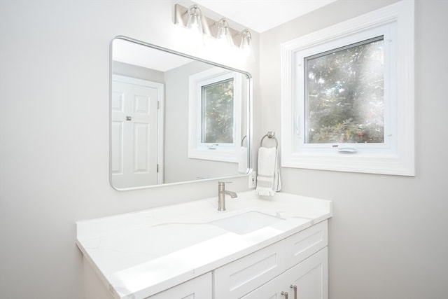 bathroom with plenty of natural light and vanity