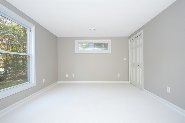 spare room featuring carpet flooring and a healthy amount of sunlight