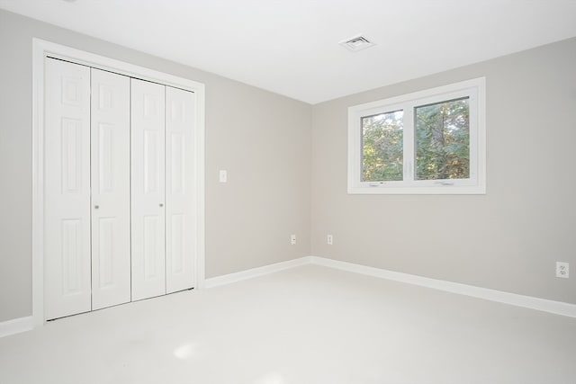 unfurnished bedroom with carpet floors and a closet