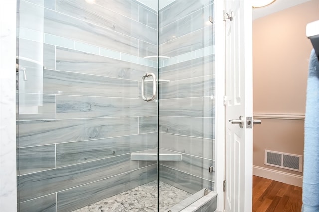 bathroom featuring hardwood / wood-style floors and an enclosed shower