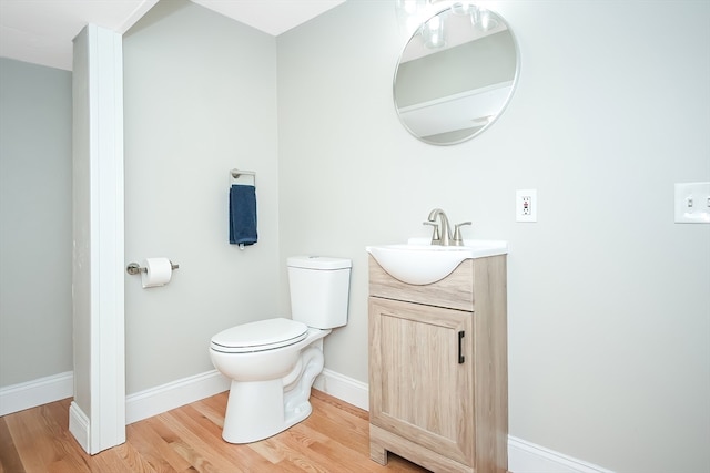 bathroom featuring hardwood / wood-style floors, vanity, and toilet