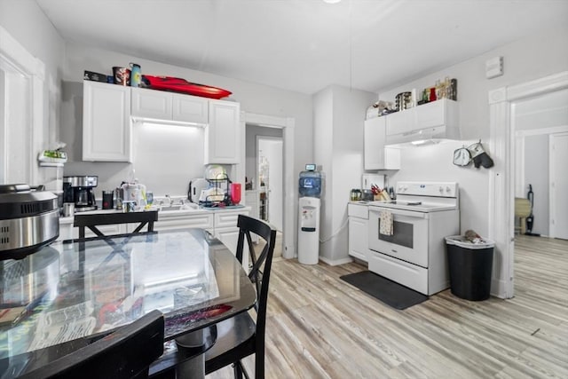 kitchen with light hardwood / wood-style flooring, white cabinets, and electric stove