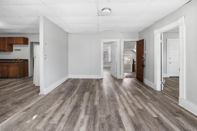 unfurnished living room with dark wood-type flooring