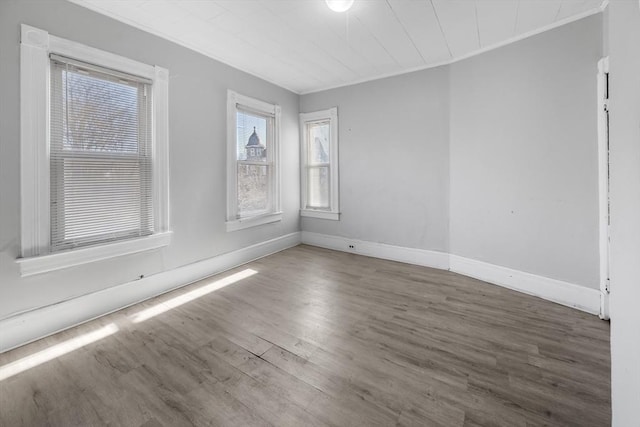 unfurnished room with crown molding and dark hardwood / wood-style floors