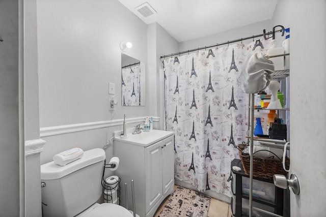 bathroom with walk in shower, vanity, toilet, and tile patterned flooring