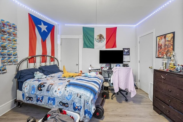 bedroom with light hardwood / wood-style flooring