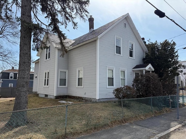 view of property exterior featuring a fenced front yard and a chimney