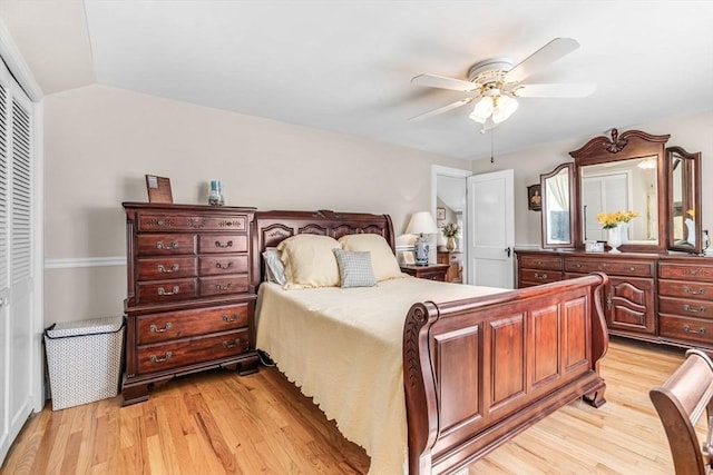 bedroom with lofted ceiling, light hardwood / wood-style floors, a closet, and ceiling fan