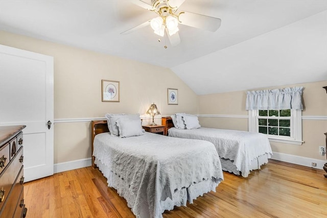 bedroom with vaulted ceiling, ceiling fan, and light wood-type flooring