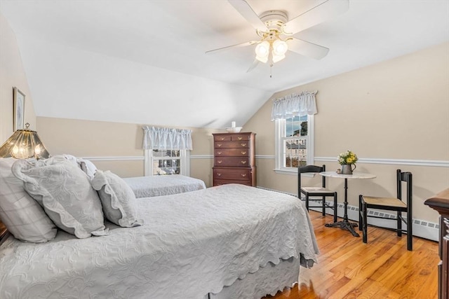 bedroom featuring hardwood / wood-style flooring, vaulted ceiling, and ceiling fan