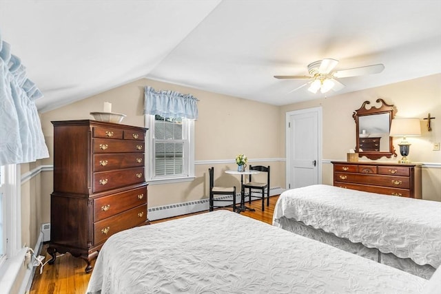 bedroom featuring lofted ceiling, hardwood / wood-style floors, a baseboard radiator, and ceiling fan