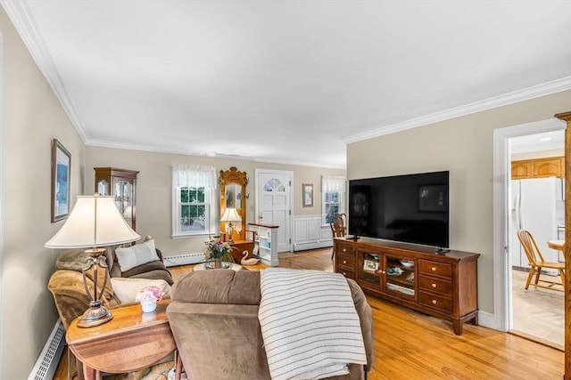 living room featuring crown molding, a baseboard radiator, and light hardwood / wood-style floors