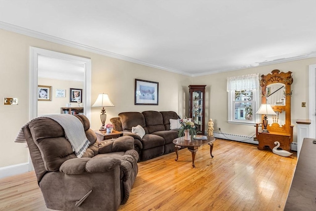 living room with a baseboard heating unit, ornamental molding, and light wood-type flooring