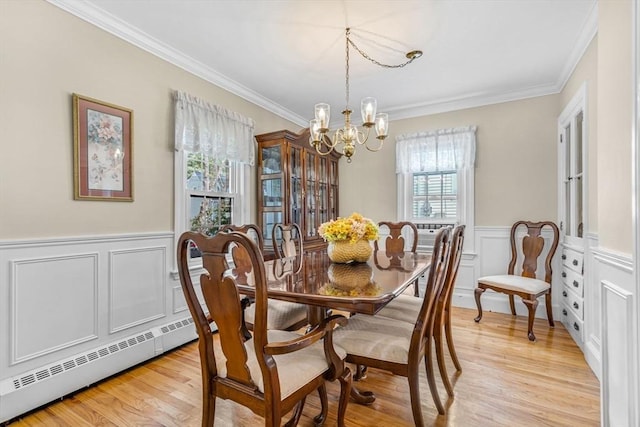 dining area featuring plenty of natural light, an inviting chandelier, and light hardwood / wood-style flooring