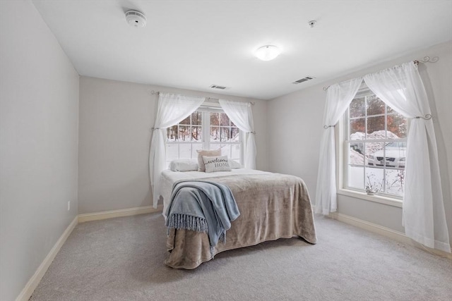 bedroom with light carpet, baseboards, and visible vents