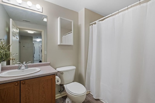 full bathroom with toilet, vanity, and visible vents