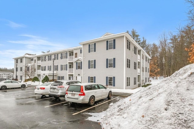 view of building exterior with uncovered parking