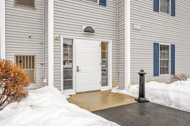 view of snow covered property entrance