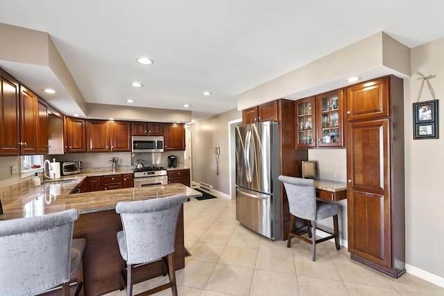 16 Windsor St, Everett, MA 02149 - kitchen with appliances with stainless steel finishes, baseboards, a sink, a peninsula, and recessed lighting