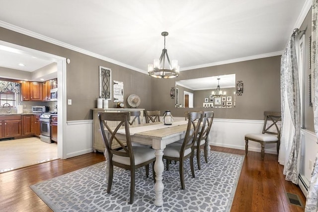 16 Windsor St, Everett, MA 02149 - dining room with a chandelier, light wood-type flooring, wainscoting, and ornamental molding