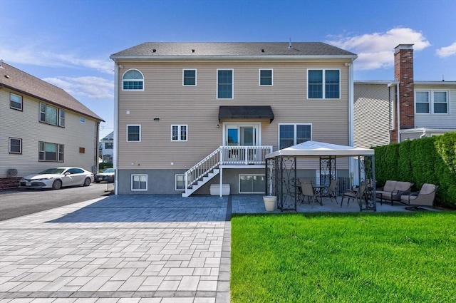 16 Windsor St, Everett, MA 02149 - rear view of house with a gazebo, a lawn, and a patio
