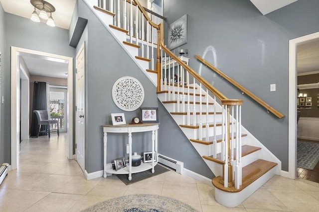 16 Windsor St, Everett, MA 02149 - stairway with baseboard heating, baseboards, and tile patterned flooring