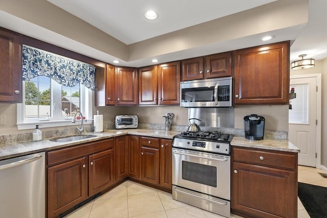 16 Windsor St, Everett, MA 02149 - kitchen with stainless steel appliances, a sink, light tile patterned floors, light stone counters, and recessed lighting