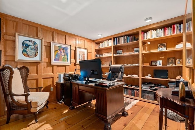 home office with hardwood / wood-style floors and built in features