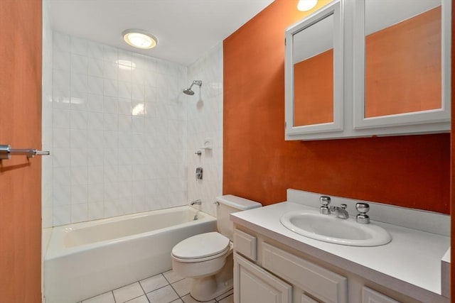 full bathroom featuring toilet, vanity, tiled shower / bath combo, and tile patterned floors