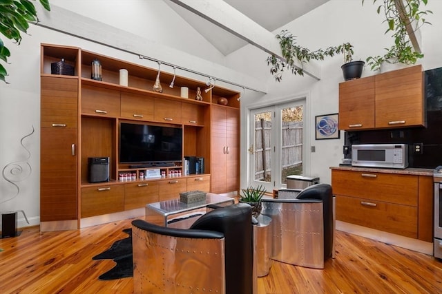 living room featuring vaulted ceiling and light wood-type flooring