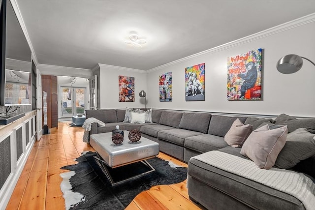 living room with hardwood / wood-style flooring, french doors, and ornamental molding