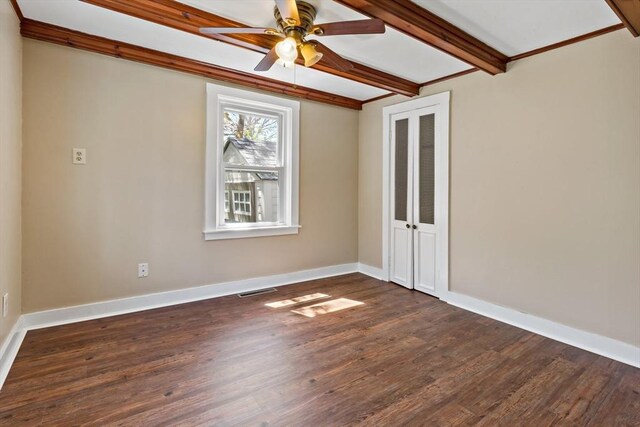 spare room featuring visible vents, beam ceiling, baseboards, ceiling fan, and dark wood-style floors