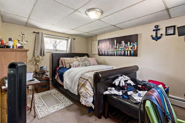 carpeted bedroom featuring a paneled ceiling