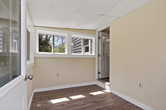 unfurnished room with dark wood-style flooring and baseboards