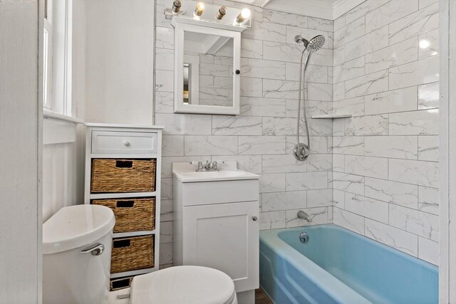bathroom featuring vanity, washtub / shower combination, and toilet