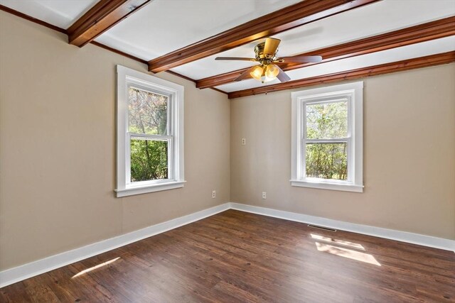 unfurnished room with baseboards, ceiling fan, dark wood-style floors, and beam ceiling