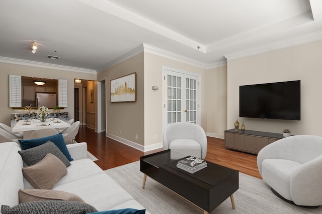 living room featuring crown molding and light hardwood / wood-style floors