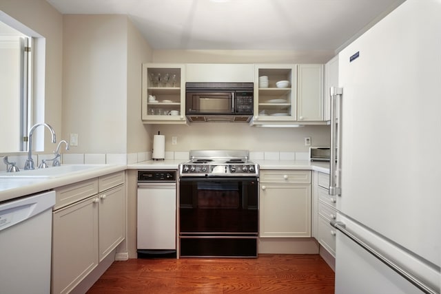 kitchen featuring wood-type flooring, white appliances, white cabinets, and sink